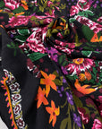Pure viscose with floral design in panels. The ground is black and the print is in the shades of green, orange, dark red, and fuchsia. Very soft, light, and flowy. Ideal for dresses, skirts, and blouses. High-quality deadstock collected in Stock from a Maison de Couture in Italy.