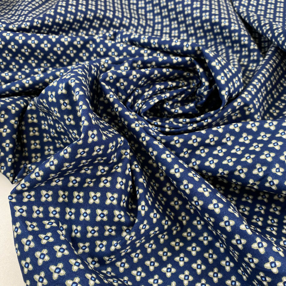 Pure cotton popeline with a blue ground and small flower design in the shades of beige. very soft and light. High-quality deadstock fabric by the meter collected in Stock from a Maison de Couture in Italy.