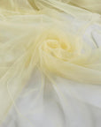 Polyester stretch tulle in light yellow color reference Tender Yellow. Very soft, light, and transparent, it adds volume and is ideal for dresses and skirts. High-quality deadstock collected in Stock from a Maison de Couture in Italy.