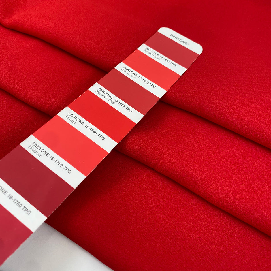 Viscose crepe, stretch in red color reference Tomato. Very soft, light, and flowy. Ideal for trousers, skirts, dresses, and blouses. High-quality deadstock collected in Stock from a Maison de Couture in Italy.
