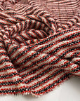 Cotton and viscose jacquard tweed fabric in white, black, red, and gold. High quality deadstock fabric collected in Stock from a Maison de Couture in Italy.