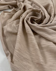 Pure cotton stretch jersey in pink beige, color reference Shell. Very soft and flowy with a slightly rough texture. High-quality deadstock collected in Stock from a Maison de Couture in Italy.