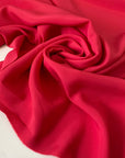 Silk and acetate crepe de chine in fuchsia color, reference Innuendo. Very soft, light and flowy, not transparent. Ideal for shirting, blouses, dresses, and skirts. High-quality deadstock collected in Stock from a Maison de Couture in Italy.