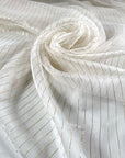 Pure silk chiffon in star white with golden lurex stripes. Very light, soft, flowy, and transparent. Ideal for dresses, skirts, blouses, and shirting. High-quality deadstock collected in Stock from a Maison de Couture in Italy.