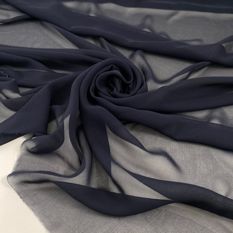 Pure silk chiffon in dark blue. Very light and soft. High-quality deadstock fabric collected in Stock from a Maison de Couture in Italy.