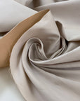 Double-face mikado in polyester and silk with pale rose tones, structured and elegant, ideal for dresses, skirts, and formal jackets. High-quality deadstock collected in Stock from a Maison de Couture in Italy.