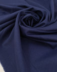 Virgin wool and silk in dark blue, with very small pied de pooule pattern in black. Very light and soft. High-quality deadstock fabric by the meter collected in Stock from a Maison de Couture in Italy.