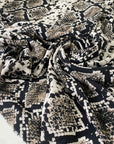 Pure viscose with a snake skin print in beige, black, and mocha tones. Very soft, light, and flowy, not transparent. Ideal for blouses, shirting, dresses, and skirts. High-quality deadstock collected in Stock from a Maison de Couture in Italy.