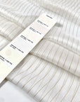 Pure silk chiffon in star white with golden lurex stripes. Very light, soft, flowy, and transparent. Ideal for dresses, skirts, blouses, and shirting. High-quality deadstock collected in Stock from a Maison de Couture in Italy.