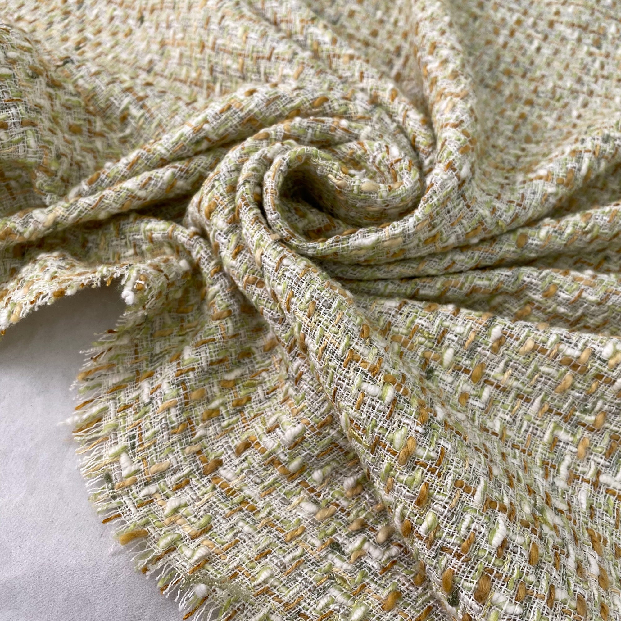 Mixed cotton tweed in pale green and ochre shade. Very soft and light. Ideal for spring jackets, skirts and dresses. High-quality deadstock collected in Stock from a Maison de Couture in Italy.
