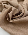 Pure wool light tweed in a tan brown melange. Very soft, medium weight, and not transparent. Ideal for jackets, skirts, or trousers. High-quality deadstock collected in Stock from a Maison de Couture in Italy.