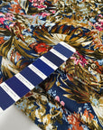 Multicolor polyester twill with beautiful floral design. In dark blue background and red, green, pink, light blue and white shades. Very light high-quality deadstock fabric by the meter collected in Stock from a Maison de Couture in Italy.
