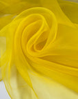 Bright yellow polyester organza transparent and light. High-quality deadstock fabric collected in Stock from a Maison de Couture in Italy.