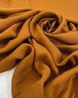 Pure viscose in soft, light and transparent rusty pecan brown. Ideal for blouses, shirts, skirts, and dresses. High-quality deadstock fabric by the meter collected in Stock from a Maison de Couture in Italy.