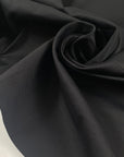 Mixed viscose stretch ottoman in black, color reference tap shoe. A little shiny and stiff. It keeps the shape and makes volume. Ideal for jackets, skirts, and trousers. High-quality deadstock fabric by the meter collected in Stock from a Maison de Couture in Italy.