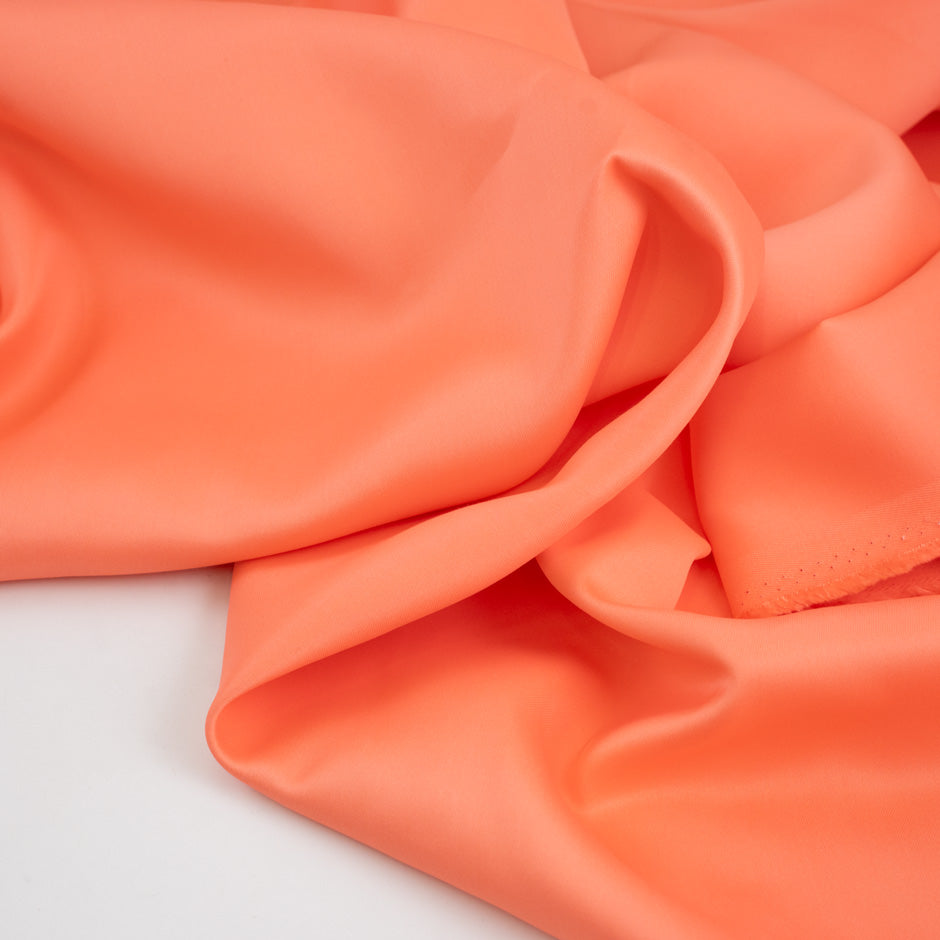 Pure viscose salmon pink cady. High-quality deadstock fabric collected in Stock from a Maison de Couture in Italy.