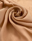 Pure viscose very soft and flowy in almost apricot pink. Ideal for shirts, skirts, dresses, and blouses. High-quality deadstock fabric by the meter collected in Stock from a Maison de Couture in Italy.