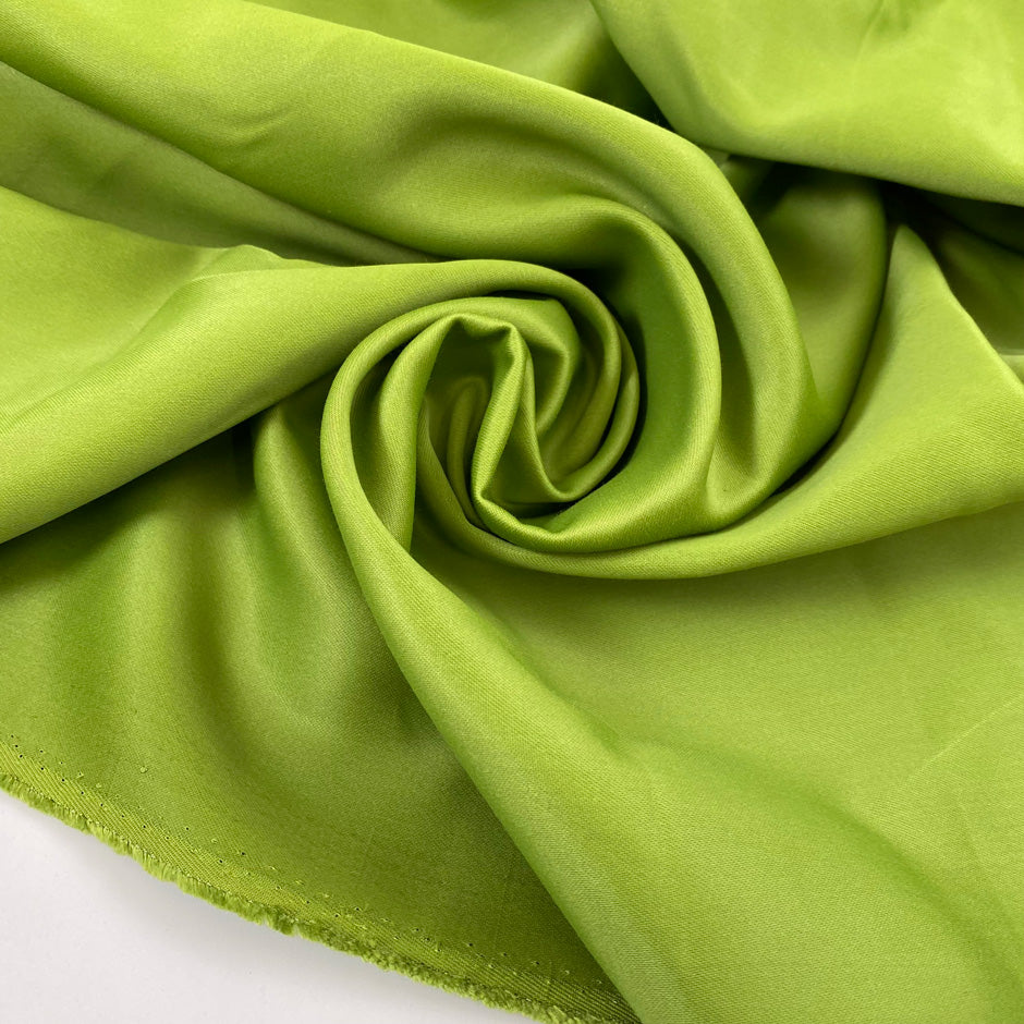Pure viscose cady, very heavy and stiff in bright olive green with shiny sides. High-quality deadstock fabric by the meter collected in Stock from a Maison de Couture in Italy.