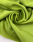 Pure viscose cady, very heavy and stiff in bright olive green with shiny sides. High-quality deadstock fabric by the meter collected in Stock from a Maison de Couture in Italy.
