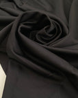Heavy punto Milano jersey, pure viscose, a little stretch, very flowy in Pirate Black. Ideal for dresses, skirts, and trousers. High-quality deadstock fabric by the meter collected in Stock from a Maison de Couture in Italy.