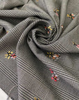 Warm polyester Prince of Wales in black and white with delicate floral embroidery. Ideal for trousers, jackets, dresses, and skirts.High-quality deadstock collected in Stock from a Maison de Couture in Italy.