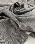 Light, white and pure wool fabric with black wires. High-quality deadstock fabric collected in Stock from a Maison de Couture in Italy.