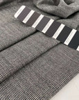 Light, white and pure wool fabric with black wires. High-quality deadstock fabric collected in Stock from a Maison de Couture in Italy.