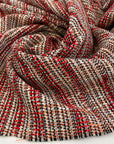 Red, black, orange and white cotton blend tweed. The fabric feels droopy and heavy. High quality deadstock fabric. 