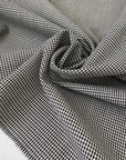 Pure wool with a pied de poule design in the shades of antique white and black sand. Stiff and rough, ideal for coats, jackets, and structured skirts. High-quality deadstock collected in Stock from a Maison de Couture in Italy.