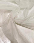 Soft polyester tulle in white with sparkling glitters. Light and delicate, perfect for dresses, skirts, blouses, and shirting.High-quality deadstock collected in Stock from a Maison de Couture in Italy.