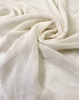Pure silk georgette in white, color reference Star White. Very soft, light, transparent, and flowy—ideal for dresses, skirts, blouses, and shirting. High-quality deadstock collected in Stock from a Maison de Couture in Italy.