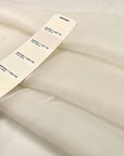 Very light pure white silk organza. It is very soft, flowing and transparent. High-quality deadstock fabric collected in Stock from a Maison de Couture in Italy.