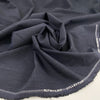 Light wool mixed with polyester with a small checker pattern in dark blue. High-quality deadstock fabric collected in Stock from a Maison de Couture in Italy. Light wool mixed with polyester with a small checker pattern in dark blue. High-quality deadstock fabric collected in Stock from a Maison de Couture in Italy.