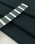 Pure wool in dark forest green with texture. A little bit stiff but flowy and medium weight. Ideal for jackets, skirts, trousers, and light coats. High-quality deadstock collected in Stock from a Maison de Couture in Italy.