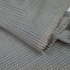 Gray checkered wool and polyester. The fabric is elastic and falling. High-quality deadstock fabric collected in Stock from a Maison de Couture in Italy. Gray checkered wool and polyester. The fabric is elastic and falling. High-quality deadstock fabric collected in Stock from a Maison de Couture in Italy.