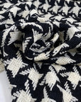 Pure wool with pied de poule design in black and white, color reference Pirate Black and Marshmallow. Heavy and structured, ideal for coats and jackets. High-quality deadstock collected in Stock from a Maison de Couture in Italy.