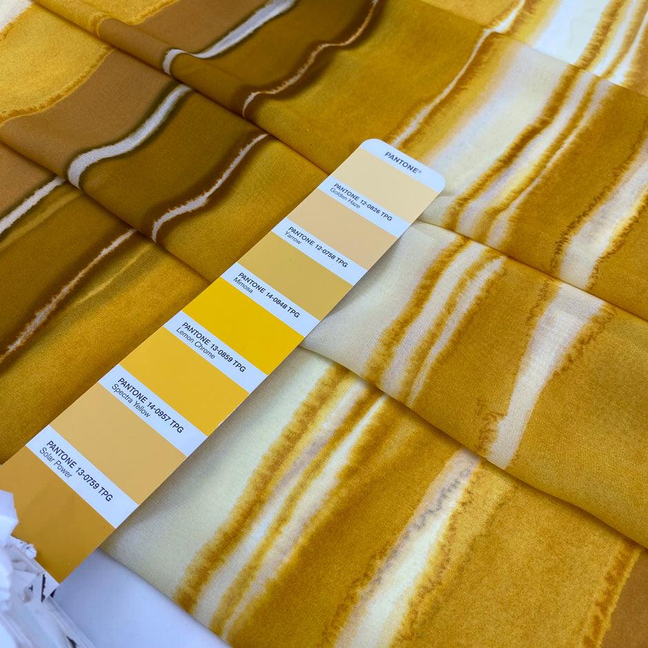 Polyester chiffon with tie-dye print in the shades of yellow mimosa. Very soft, light, transparent, and flowy. Ideal for skirts, blouses, and dresses. | Pantone 14-0848 TPG