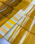Polyester chiffon with tie-dye print in the shades of yellow mimosa. Very soft, light, transparent, and flowy. Ideal for skirts, blouses, and dresses. | Pantone 14-0848 TPG