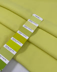 Polyester cady in bright yellow, color reference Sunny Lime. Very soft, light, and flowy, not transparent. Ideal for trousers, dresses, and skirts. High-quality deadstock collected in Stock from a Maison de Couture in Italy.