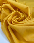 Structured silk and viscose in banana yellow. It is very soft and not transparent. The fabric is structured. High-quality deadstock fabric collected in Stock from a Maison de Couture in Italy.