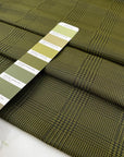 Soft tafta in polyester in olive green with prince of Wales design. High-quality deadstock fabric collected in Stock from a Maison de Couture in Italy.