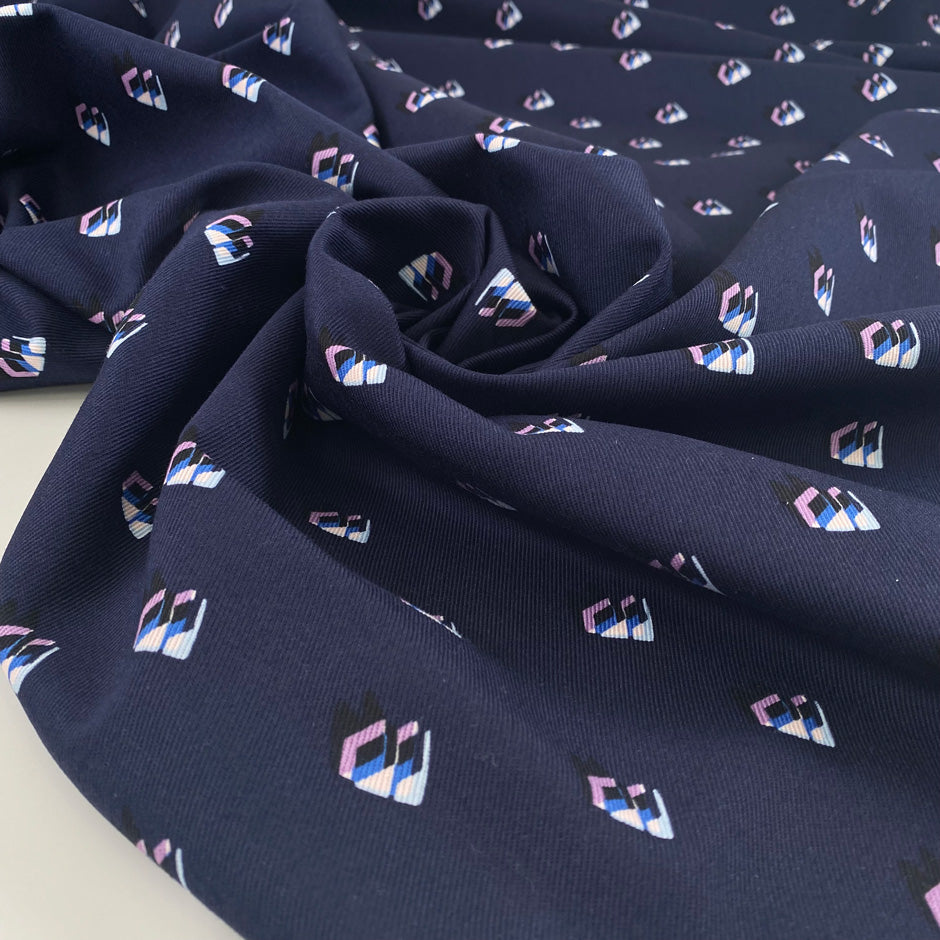 Pure structured and heavy cotton gabardine with dark blue base and geometrical print. Premium deadstock fabric from an Italian Maison de Couture."