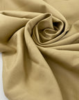 Stretch cotton piqué in very light camel color, with structured textured and very soft. High-quality deadstock fabric by the meter collected in Stock from a Maison de Couture in Italy.