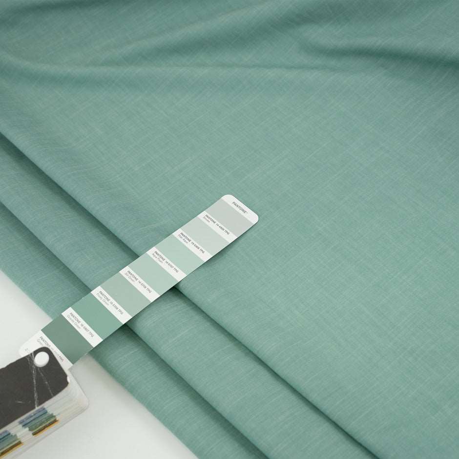 Irregular soft yarn green dyed cotton. High-quality deadstock fabric collected in Stock from a Maison de Couture in Italy.