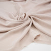 Beige and semi-trasparent polyester crepe cady. High quality deadstock fabric.