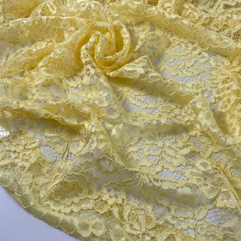 Polyester lace in limelight yellow with double scallop. Light and decorative, ideal for dresses, blouses, and skirts. High-quality deadstock collected in Stock from a Maison de Couture in Italy.