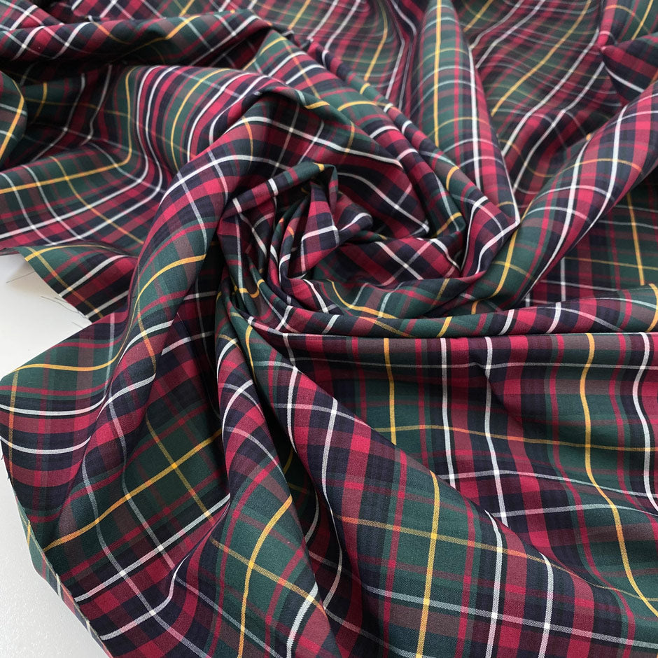 Pure cotton poplin with tartan design in the shades of dark green, red and yellow. Crunchy, flowy and not transparent. Ideal for shirts, dresses and skirts. High-quality deadstock collected in Stock from a Maison de Couture in Italy.