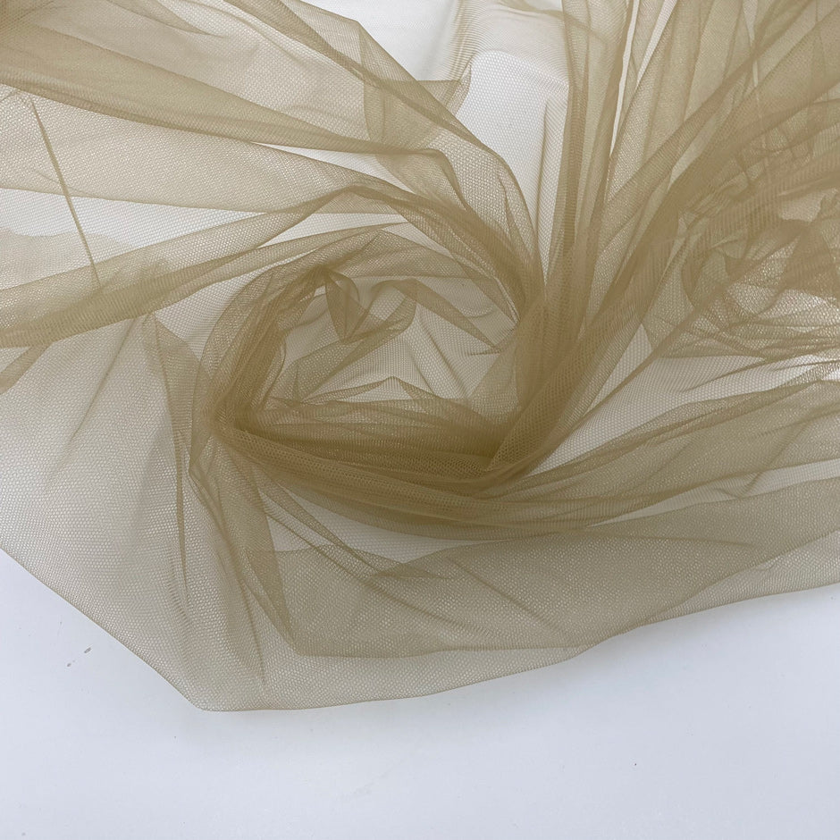 Soft and transparent polyester micro tulle beige. High-quality deadstock fabric collected in Stock from a Maison de Couture in Italy.
