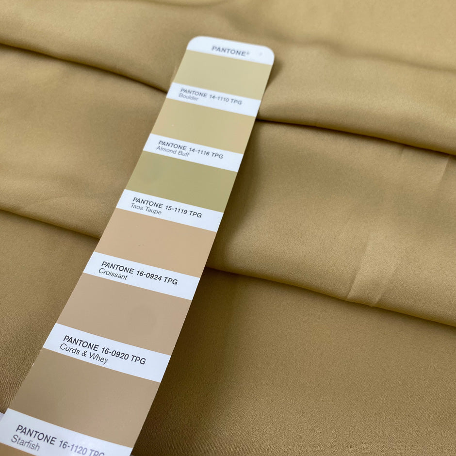 Beige polyester crêpe de chine with a lightweight fluid drape and matte finish ideal for elegant blouses dresses and linings. High-quality deadstock collected in Stock from a Maison de Couture in Italy.
