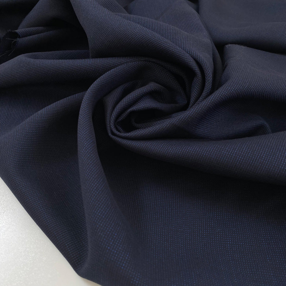 Pure virgin wool in dark blue with a subtle textured micro square design. Very soft, light, and not transparent. Ideal for shirting, dresses, and lightweight garments. High-quality deadstock collected in Stock from a Maison de Couture in Italy.